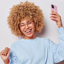 Woman with curly hair and smart phone